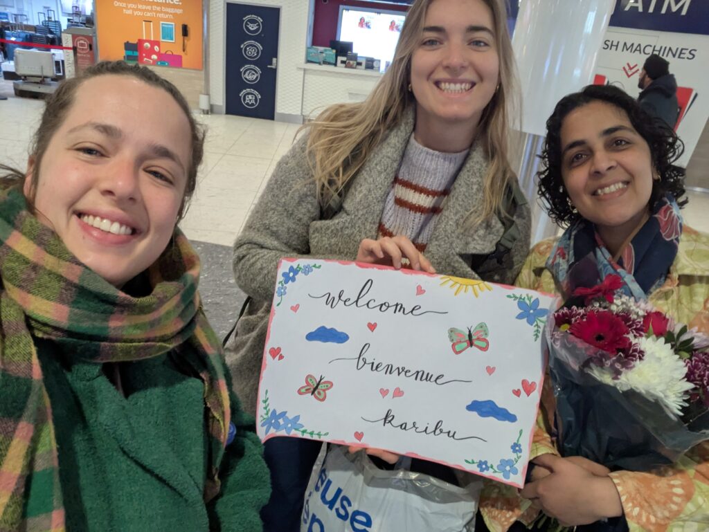 Meet the Edinburgh Refugee Sponsorship Circle – a Community Sponsorship group based in the heart of Scotland’s capital. This image shows three smiling people holding up a welcome sign at an airport